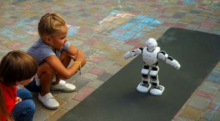 Kremenchuk, Ukraine - 3.08.2019: Demonstration of high technology of the future, The Smart UBTECH Humanoid Robot surrounded by childrenのeditorial素材