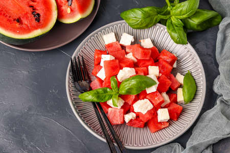 Summer salad of watermelon, feta cheese and green basil, healthy food, close-up, horizontal orientation, top viewの写真素材