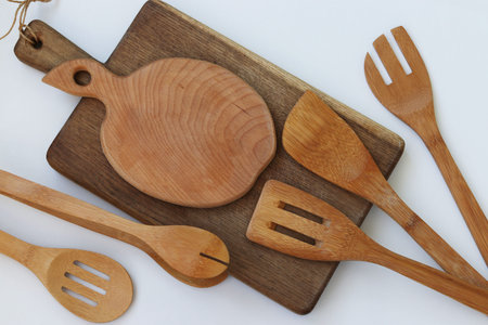 Wooden kitchen utensils on a white background, top view, horizontal orientation, closeupの写真素材