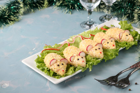 Festive snack Mices for 2020 of cheese, eggs and crab sticks on light blue background, Symbolic food for new year, Closeup, horizontal orientationの写真素材