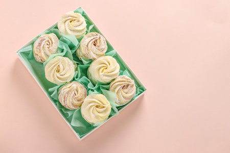 Homemade zephyr or marshmallows in a box on a pink background, horizontal orientation, Top view