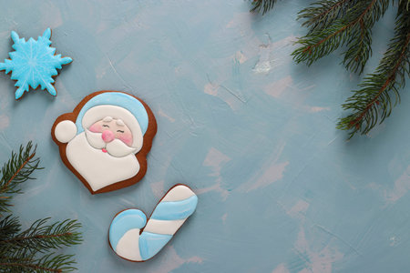 Gingerbreads Santa Claus, cane and snowflake on a light blue background, Happy New Year, horizontal...