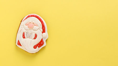 Gingerbread Santa Claus on a festive yellow background, Happy New Year, horizontal orientation, Copy...