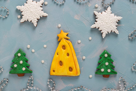 Gingerbread cookies christmas tree and snowflakes on a light blue background, Top view, Closeup, horizontal orientationの写真素材