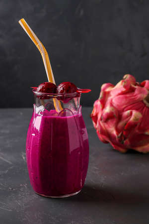 Homemade tropical smoothie made of dragon fruit on a dark background, vertical orientation, Closeupの写真素材