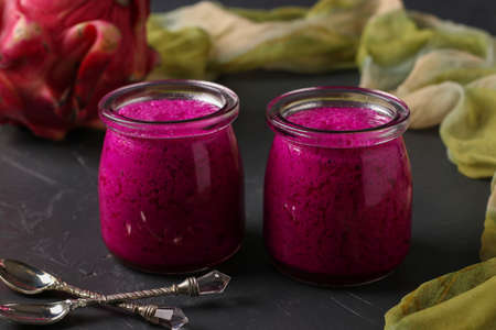 Homemade tropical smoothie made of dragon fruit on a dark background, horizontal orientation, Closeupの写真素材