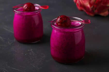 Homemade tropical smoothie made of dragon fruit on a dark background, horizontal orientation, Closeupの写真素材