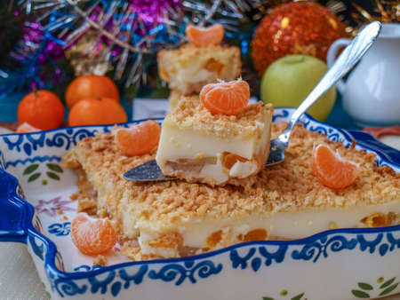 Homemade pie with apples and tangerines in ceramic form on a New Year background, Closeup, horizontal orientation, Festive still lifeの写真素材