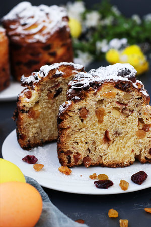Easter cake Cruffin and colorful eggs on a dark background, The concept of the spring orthodox...