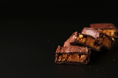 Italian chocolate with biscuit and nuts on a black background, Closeup, Copy space