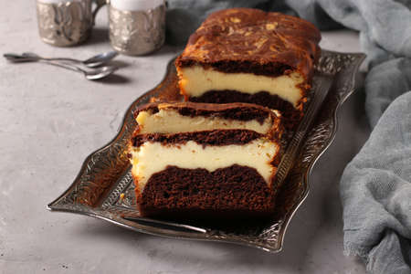 Homemade chocolate muffin with cottage cheese located on a metal tray on a gray background, Closeup, Horizontalの写真素材