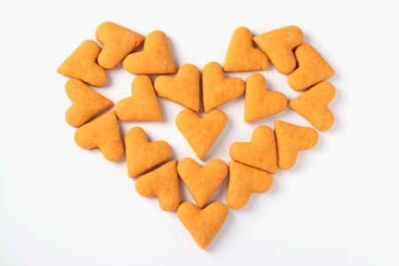 Heart made from ginger cookies in the shape of hearts on a white background, Concept for Valentines Day, View from aboveの写真素材