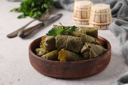 Dolma - stuffed grape leaves with rice and meat on light gray background. Traditional Caucasian, Greek, Ottoman and Turkish cuisine, Closeupの写真素材