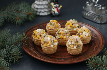 Tartlets with tuna, corn and eggs on a plate on dark background, Horizontal formatの写真素材