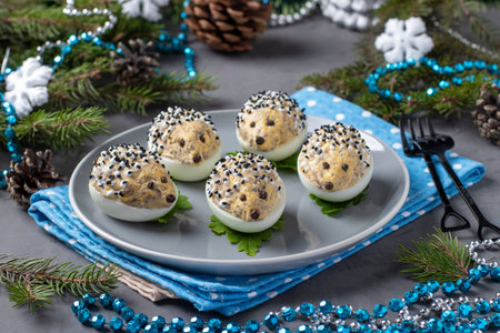 Snack hedgehogs made of stuffed eggs with cheese and champignons on a gray background. Funny food...