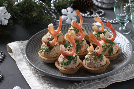 Tartlets with crab sticks, cheese and shrimps in the New Years composition. Delicious festive snack.の写真素材