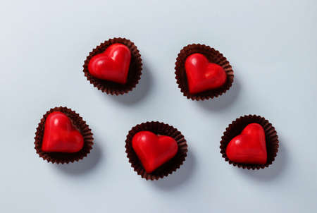 Heart-shaped chocolates on a light blue background. View from aboveの写真素材