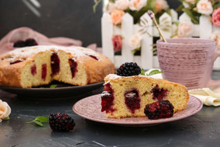 Piece homemade pie with blackberries and cup of cofee on dark background.の写真素材