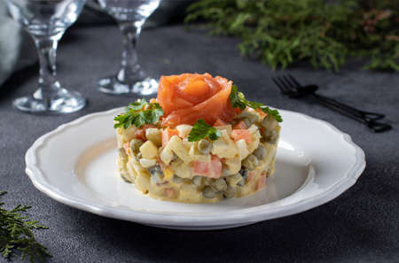 Traditional Russian salad Olivier with salted salmon on a dark background. Festive presentation.の写真素材