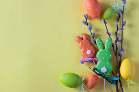 Easter colorful gingerbreads in the form of cute rabbits and eggs on yellow background. Easter concept. Top viewの写真素材