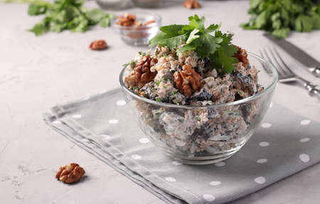 Georgian salad with eggplant and walnuts in a transparent bowl on gray background. Traditional appetizer of Georgian cuisineの写真素材
