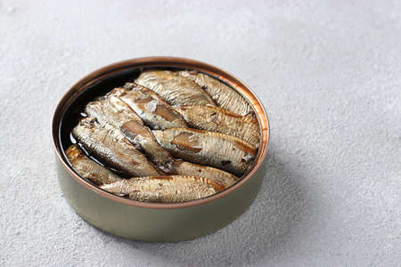 Baltic sprats in an tin can on a light gray background. Close-upの写真素材