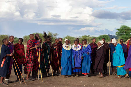 Men and women of Masai Tribe dancing and singing outdoors in traditional attire 12/16/2021 Arusha/Tanzaniaのeditorial素材