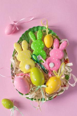 Easter gingerbread in the form of cute rabbits and eggs on pink background. spring church holiday....