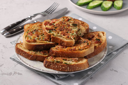 Hot sandwiches with potatoes and sausage in plate on light gray table