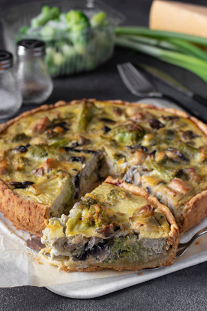Quiche with chicken, mushrooms, broccoli and cheese, homemade traditional french pie with cut pieceの写真素材