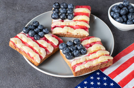 American flag sandwiches with blueberry, banana and berry jam on toast bread on gray plateの写真素材