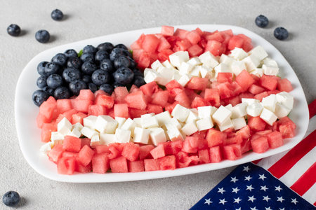 USA Independence Day salad idea with blueberries, feta and watermelon in the shape of American flag on gray background, 4th of Julyの写真素材