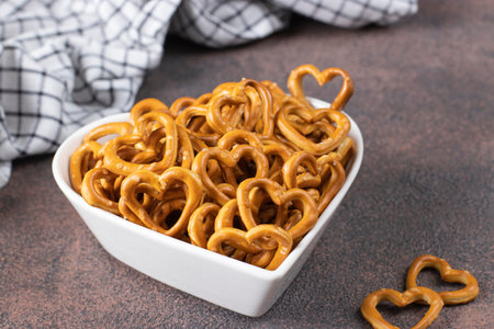 Salty heart-shaped crackers in a heart-shaped plate, Snack for Valentines Dayの写真素材