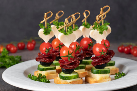Canape with cheese, cherry tomatoes, sausage and black olives, Close upの写真素材