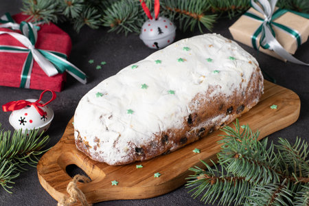 Christmas German Stollen with dry fruits and nuts on wooden board. Traditional treats. Close upの写真素材