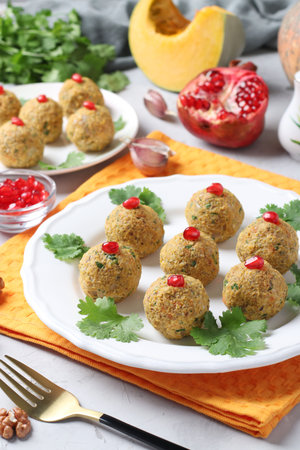 Traditional Georgian appetizer pkhali from pumpkin garnished with pomegranate seeds on light gray...