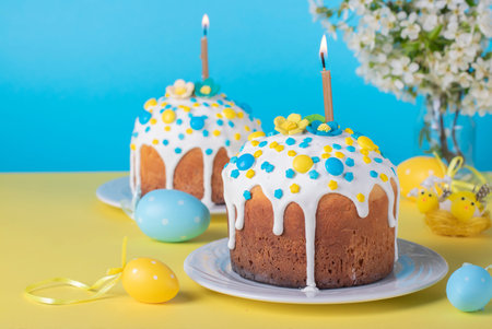 Easter cakes on blue background with yellow and blue eggs