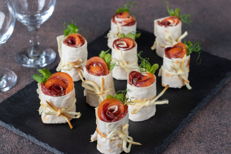 Appetizer from pita bread in shape of roses with tomato, sausage and cheese