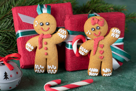 Cookies Gingerbread man and red paper gift on festive new year background