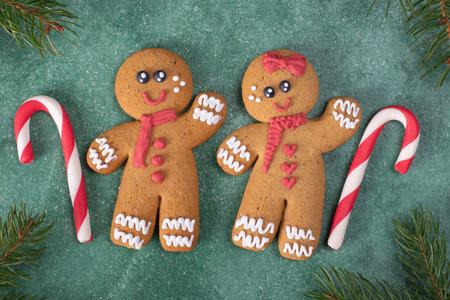 Cookies Gingerbread mans and sweet canes on green new year background