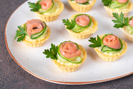 Tartlets in shape of roses with salted salmon and cucumber, festive snack for Mother Day, Valentines Day or birthdayの写真素材