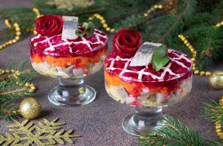 Holiday salad Herring under fur coat in two salad bowl on brown backgroundの写真素材