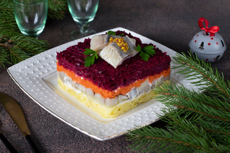 Traditional holiday salad Herring under fur coat on white plate, decorated with slices herringの写真素材