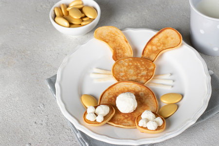 Bunny-shaped pancakes and cup of milk are a fun idea for kid breakfastの写真素材