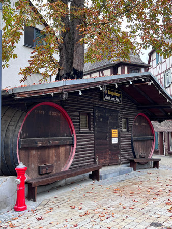 A wooden kiosk or bar, designed in the shape of two large beer kegs, advertises beer, Braubach,...
