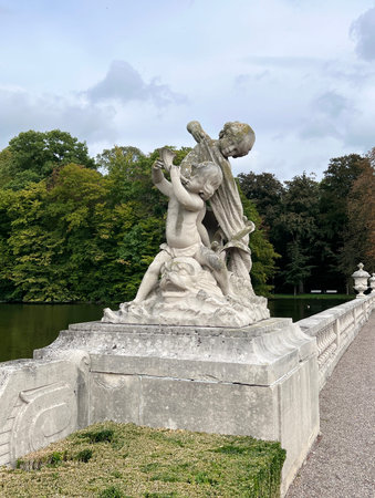 A sculpture in Nordkirchen depicting children - putti playing on the shore of the palace moat, North Rhine-Westphalia, Deutschland, Westphalian Versaillesの写真素材