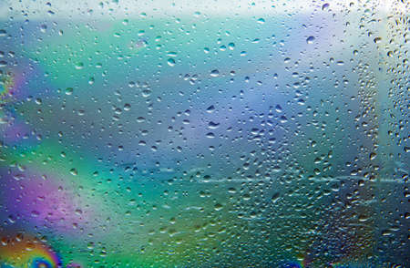 a raindrop on the reflected different color windowの写真素材