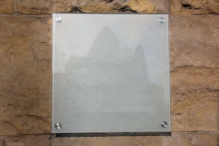 glass grey plate with a castle image on a stone backgroundの写真素材