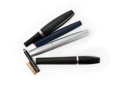 isolated three mascaras, eyeshadow and lipstic on a white background