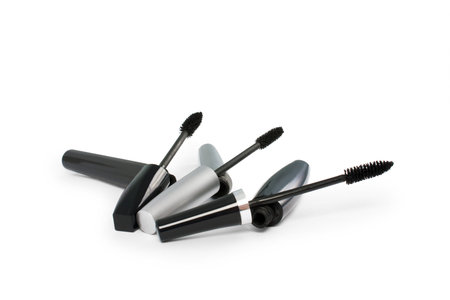 three open mascaras on a white background isolated